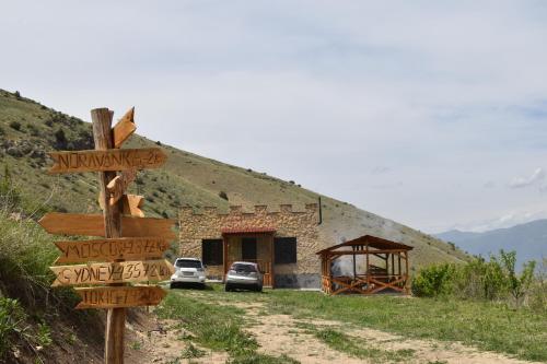a sign with arrows in front of a building at Cottage near Noravank, Areni, Sauna, Wine in Areni