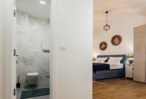 a bedroom with a bed and a bathroom at Vila Đirada in Imotski