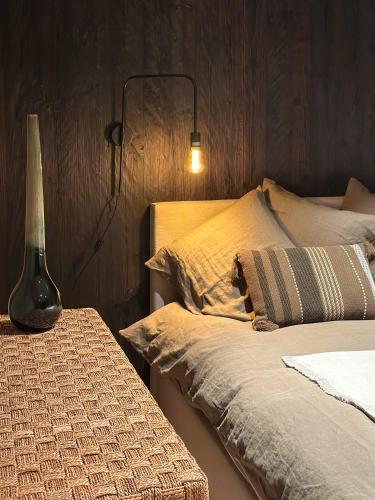 a bedroom with two beds with a lamp and a pillow at La Roche-en-Ardenne, La Rive 4P or La Forêt 17P in Mellet