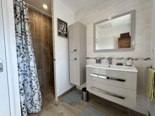 a bathroom with a sink and a mirror at 669 - Maison 4 personnes en centre bourg d'Erquy in Erquy