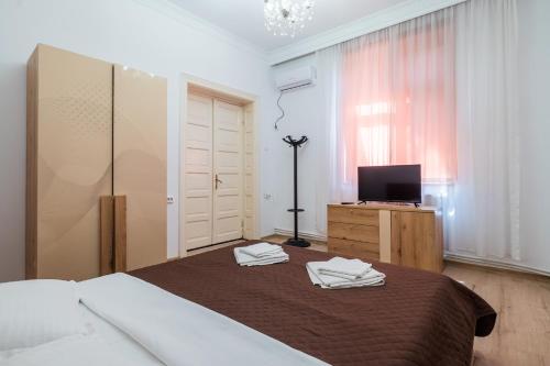 a bedroom with a bed with two towels on it at Villa Dumbrava Rosie in Constanţa