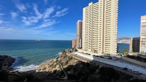 a view of the ocean with buildings and a bridge at Observador de delfines in Benidorm