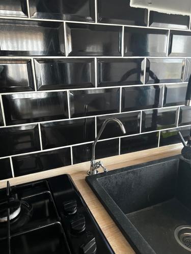a kitchen with a sink and a counter top at Apartament Maya Lumina in Lumina