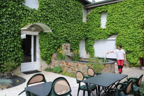 a person walking in front of a green wall at Ch d'Hôte LE BON ABRI JURA in Marigny