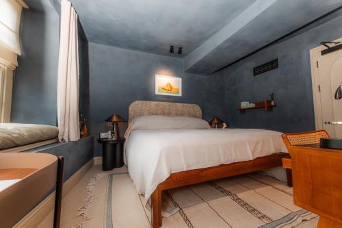 a bedroom with a bed and blue walls at BULL Burford in Burford