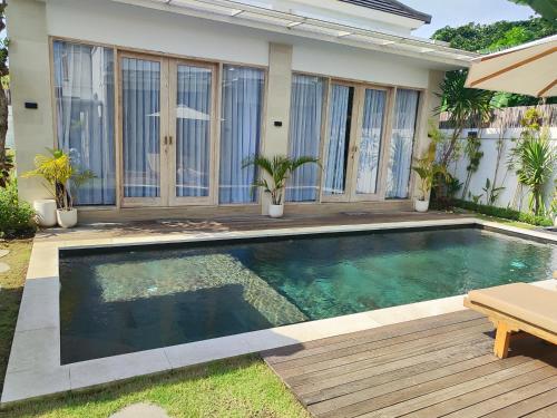 a swimming pool in the backyard of a house at Savana Villas Tanah Lot in Tanah Lot
