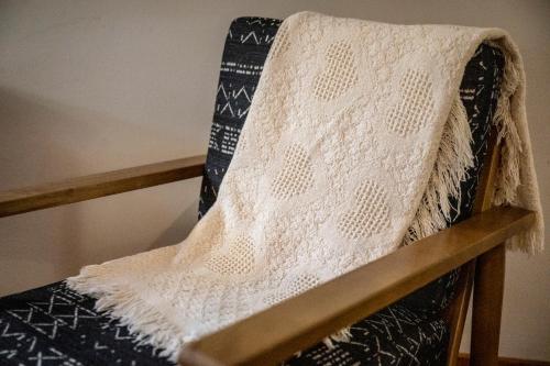 a white blanket sitting on top of a chair at Bear Tracks Lodge By Avada Properties in Sevierville