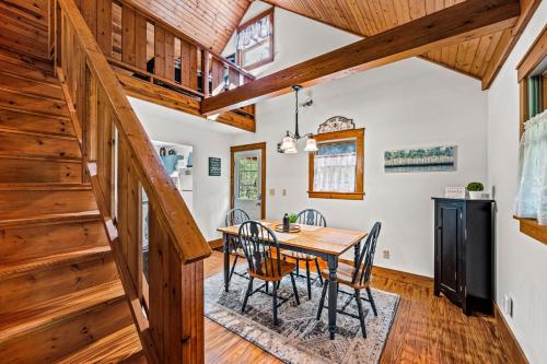 a dining room with a table and chairs and wooden ceilings at Bear Tracks Lodge By Avada Properties in Sevierville