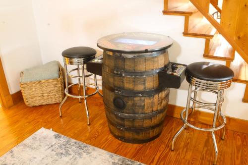 a barrel with two stools and a table in a room at Bear Tracks Lodge By Avada Properties in Sevierville