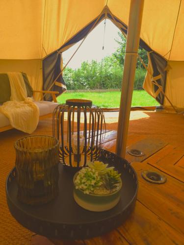 a plate of food on a table in a tent at Bell Tent Village Parks in Nottingham