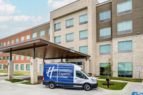 a delivery van parked in front of a building at Holiday Inn Express & Suites Austin Airport East by IHG in Austin