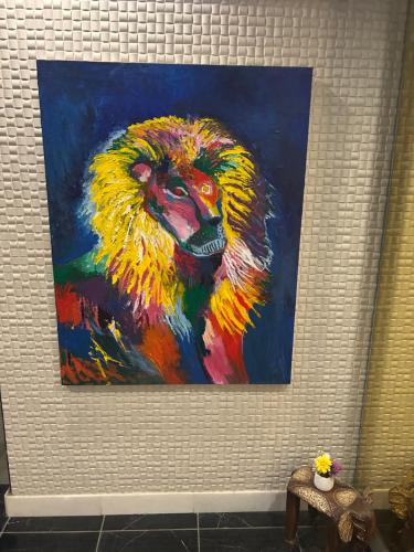 a painting of a lion on a wall at メルシアターリゾート1001 in Wada