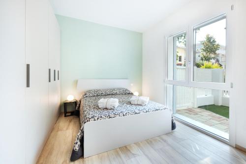 Postel nebo postele na pokoji v ubytování Katia's home - 5 minuti da Fiera di Rimini e 50 mt dal mare