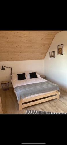 a bedroom with a large bed in a room at Domki Rewal kalimera-sun in Rewal