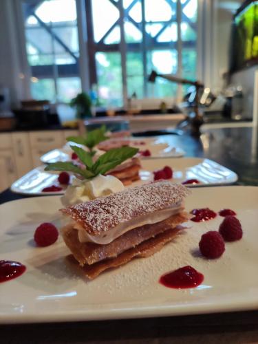 a white plate with some food on a table at Atelier des sens 89 in Évry