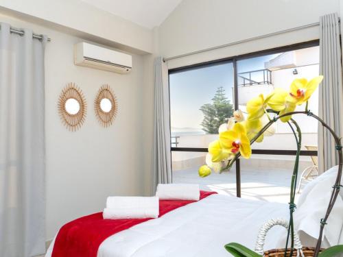 a bedroom with a bed and a window with a view at Hotel Palace 1 in Florianópolis