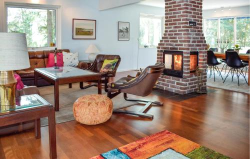 a living room with a brick fireplace and a couch at Amazing Home In Höllviken With Wifi in Höllviken