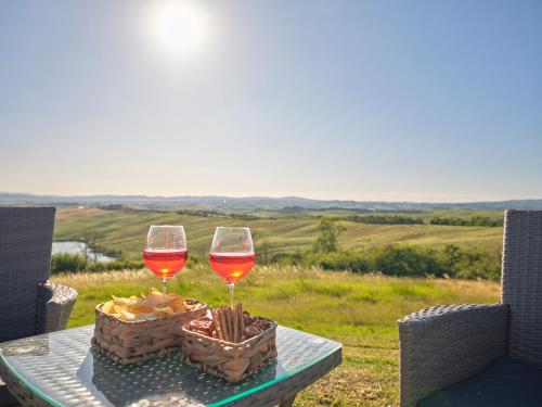 two glasses of wine sitting on a table at Casa Vacanze Santa Caterina in Asciano