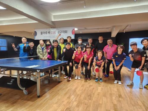 a group of people standing around a ping pong table at Forest Hangang in Seoul
