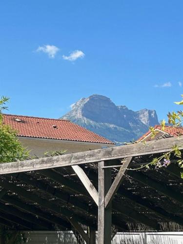 a view of a mountain with a house and a roof at Appartement LE VERSOUD 