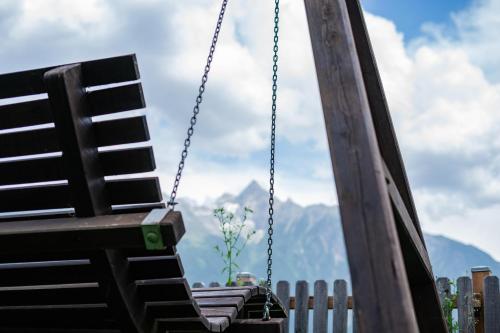 a swing with a view of the mountains at Ferienhaus Ötztal-Lodge in Sautens