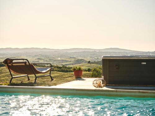 a bench sitting next to a swimming pool at Casa Vacanze Santa Caterina in Asciano