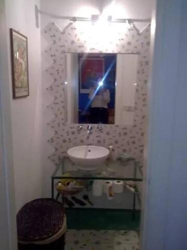 a bathroom with a sink and a mirror at Torretta 16 red room in Tuscania