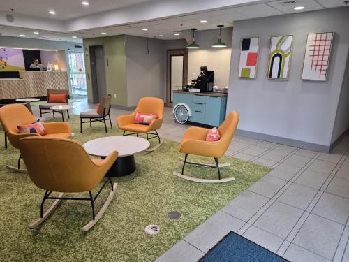 a waiting room with chairs and a table and a counter at Spark by Hilton Lancaster in Lancaster