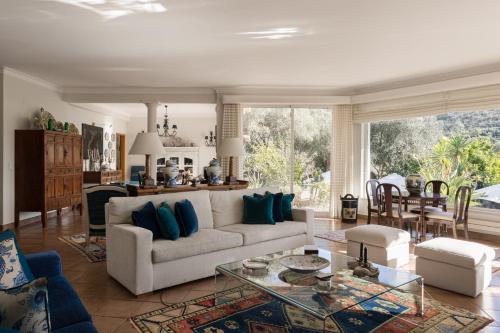 a living room with a couch and a table at Villa in Sesimbra Pool Tennis Breakfast in Sesimbra