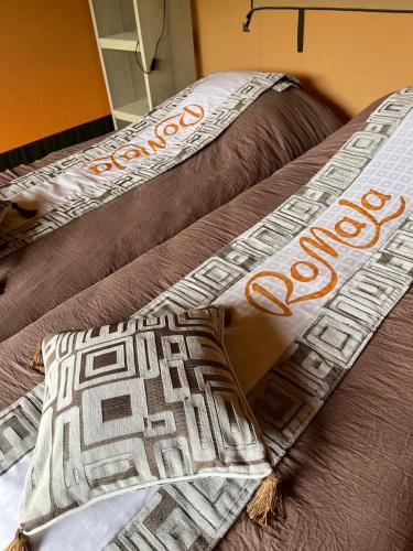 two beds with brown sheets and a pillow on them at Romala's Mini Glamp in Kiel