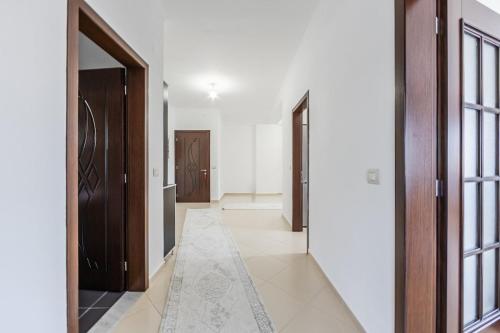 a hallway with wooden doors and a rug at Hometown Apartment 2 in Gjirokastër