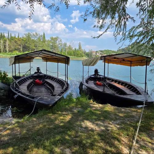 two boats are parked on the water in a lake at Vala in Ploče