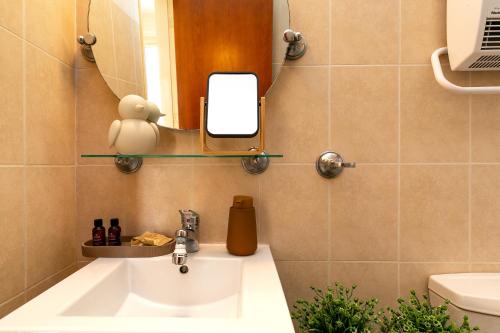 a bathroom with a sink and a mirror at Seaview Villa in Peyia | Private pool & jacuzzi by VICHY Holidays in Paphos
