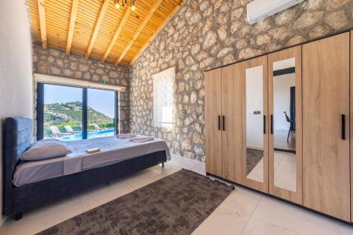 a bedroom with a bed and a large window at VillaVista07 in Kaş