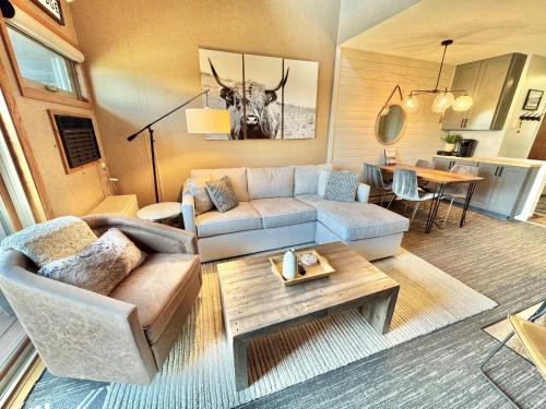 a living room with a couch and a table at Ski in Ski out 1 Bed plus Loft BEST VIEWS IN LUTSEN in Lutsen