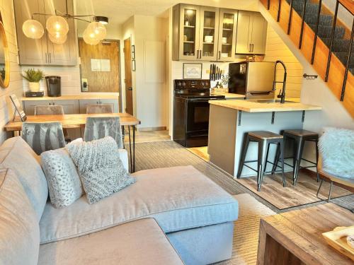 a living room with a couch and a kitchen at Ski in Ski out 1 Bed plus Loft BEST VIEWS IN LUTSEN in Lutsen