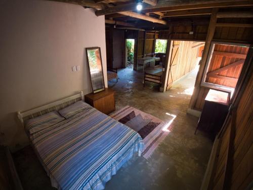 a bedroom with a bed and a mirror in it at cedro do ronca in Parati-Mirim