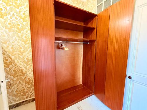 a wooden cabinet with a glass door in a bathroom at Appartement 4 prsn Parking Proche Citadelle in Besançon