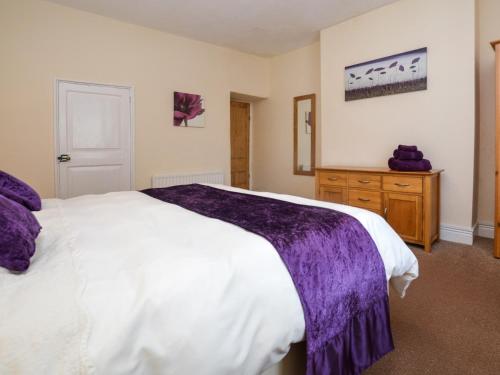 a bedroom with a large white bed and a wooden dresser at 2 Bed in Bideford 37262 in Bideford