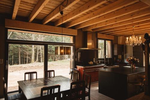 a kitchen and dining room with a dining table and a dining room at Le chalet de Nicolas - Your Nature Exclusive Retreat ! in Le Tholy