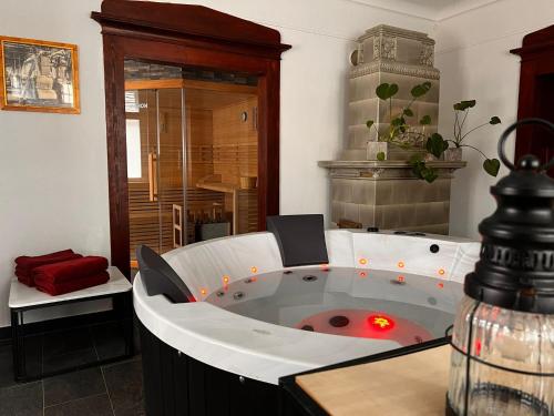 a jacuzzi tub with a red light in a room at CG Haensch in Großschönau