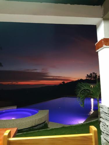 a wall mural of a night sky with a swimming pool at Villa MountainView Guesthouse in Dimiao