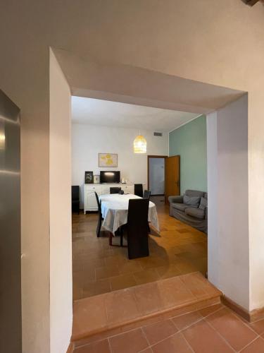 a living room with a table and a couch at The Tuscany Rose in Pistoia