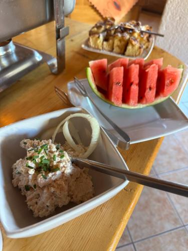 a plate of food with fruit on a table at Penzion Slovakia in Ždiar