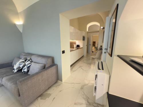 a living room with a couch and a kitchen at Luxury and Exclusivity on the Seafront in Alassio in Alassio