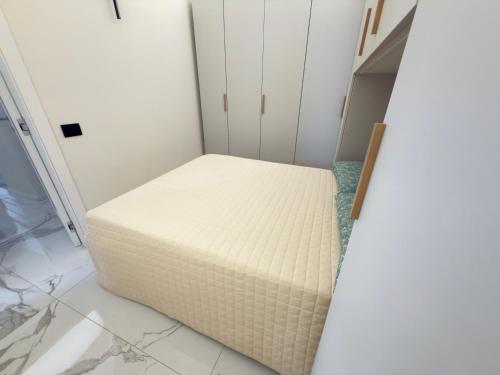 a bed in a room next to a door at Luxury and Exclusivity on the Seafront in Alassio in Alassio