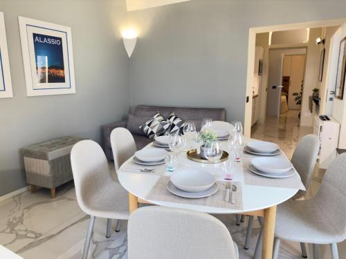 a white dining room with a white table and chairs at Luxury and Exclusivity on the Seafront in Alassio in Alassio
