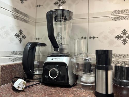 a black and white blender sitting on a counter at Bukoto Ntinda 1 bedroom in Nalakonge
