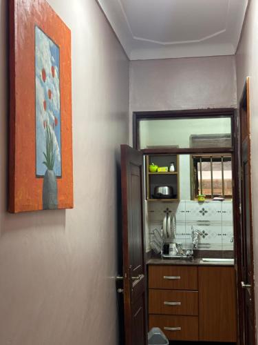 a bathroom with a sink and a mirror at Bukoto Ntinda 1 bedroom in Nalakonge