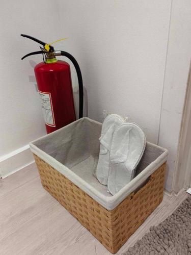 a basket with a fire extinguisher and a fire hydrant at KRYSTL KRIB Azure North in San Fernando
